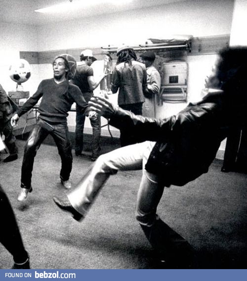 Bob Marley and Jimi Hendrix playing soccer backstage before a show.